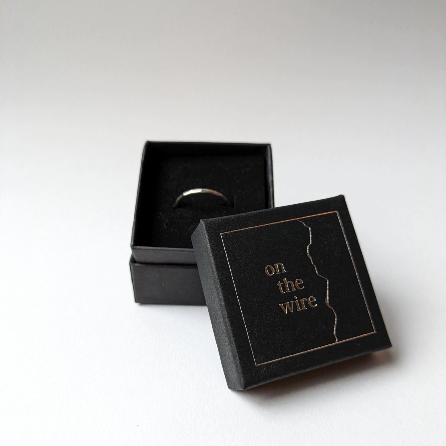 Stacker ring in branded gift box on white background