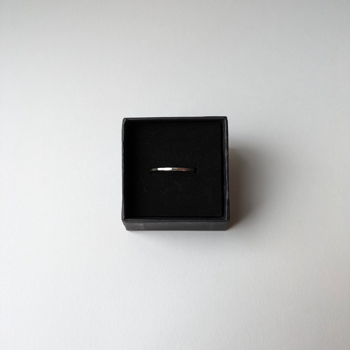 Stacker ring in black gift box on white background