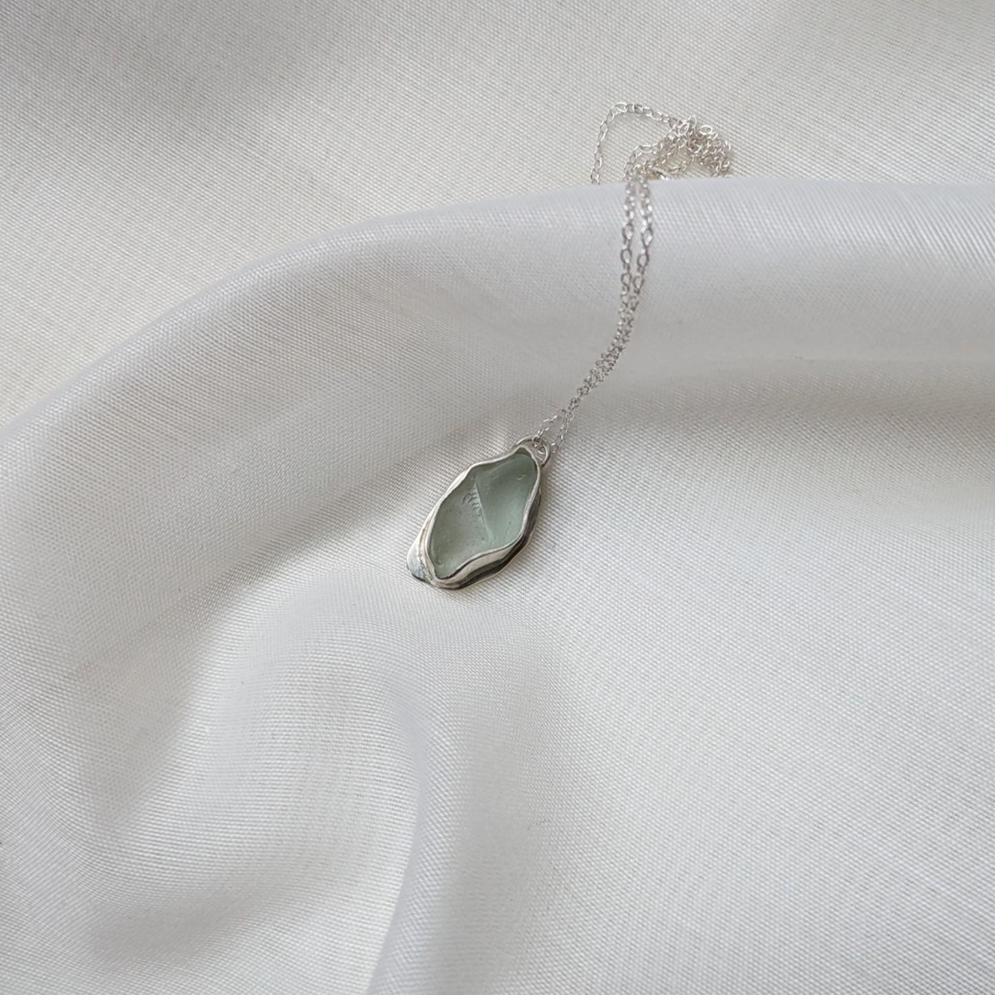 Turquoise sea glass necklace on white silk