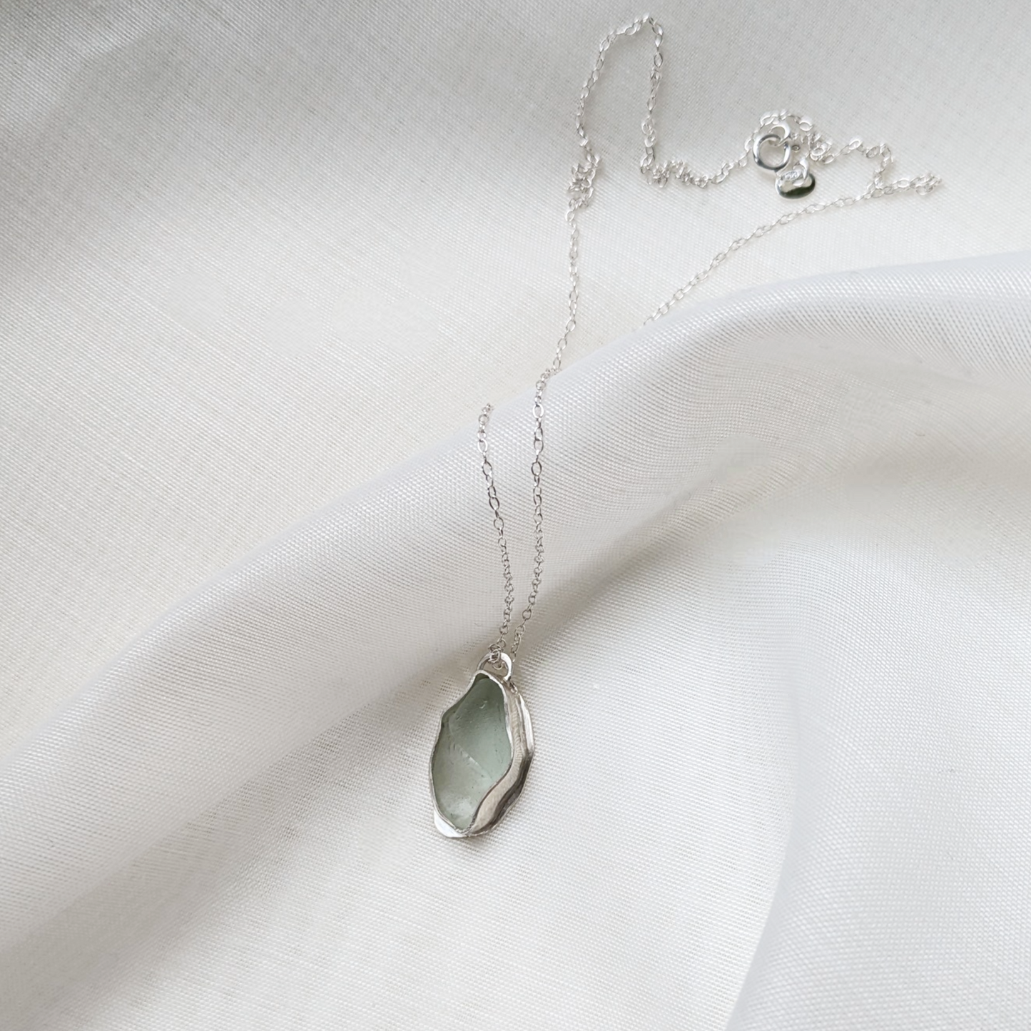 Turquoise sea glass necklace on white silk
