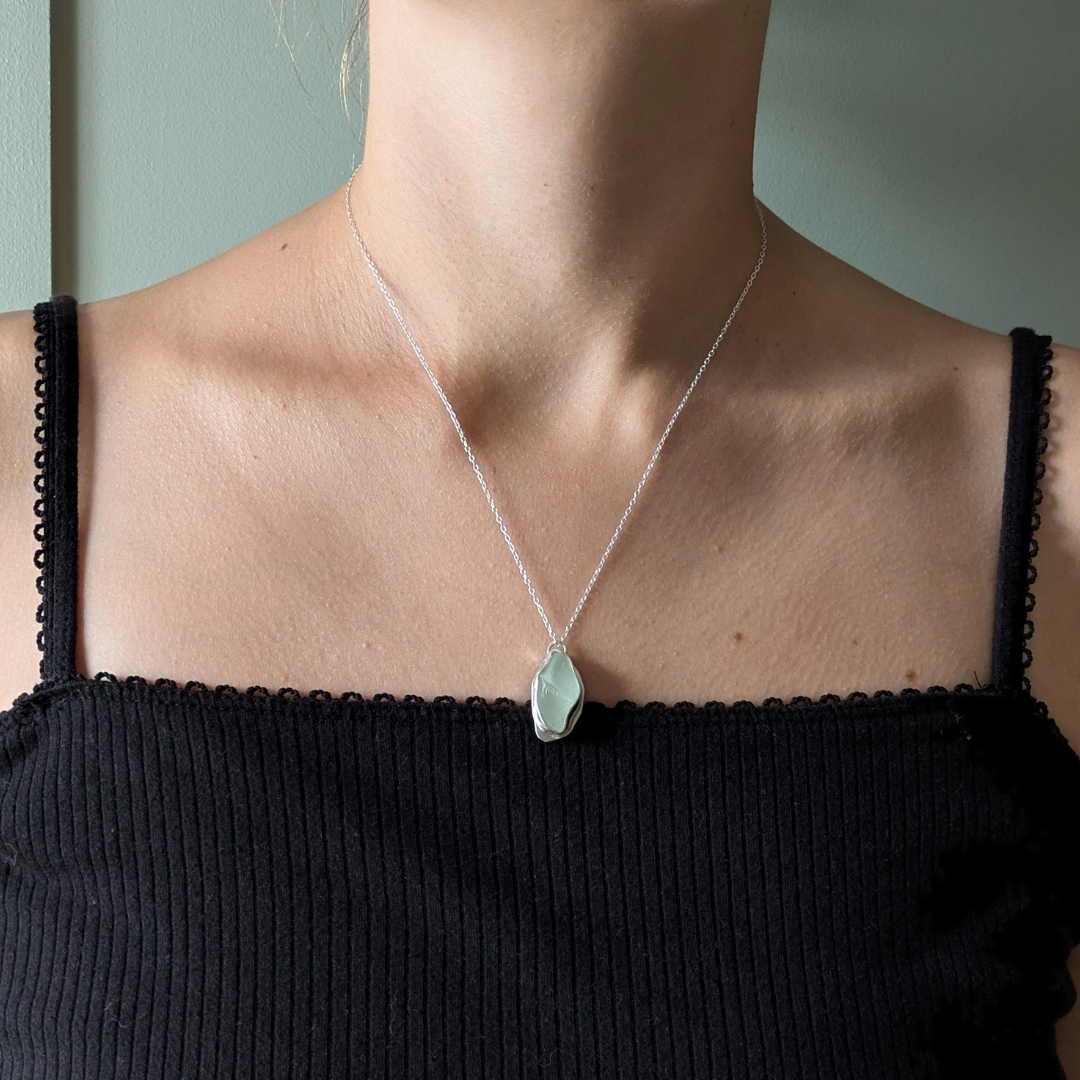 Close up of woman wearing blue sea glass pendant