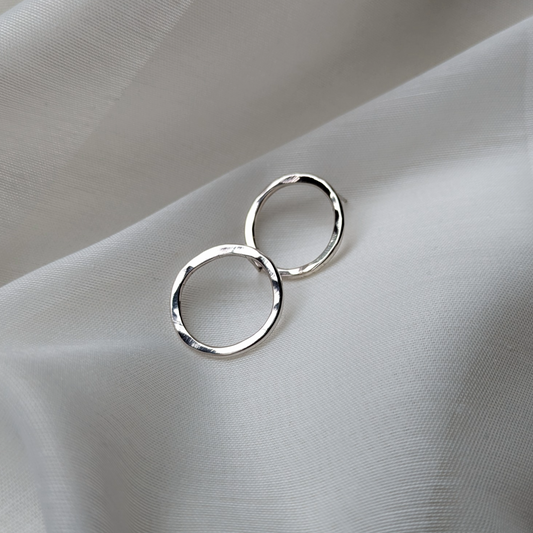 Big silver circle studs on white silk