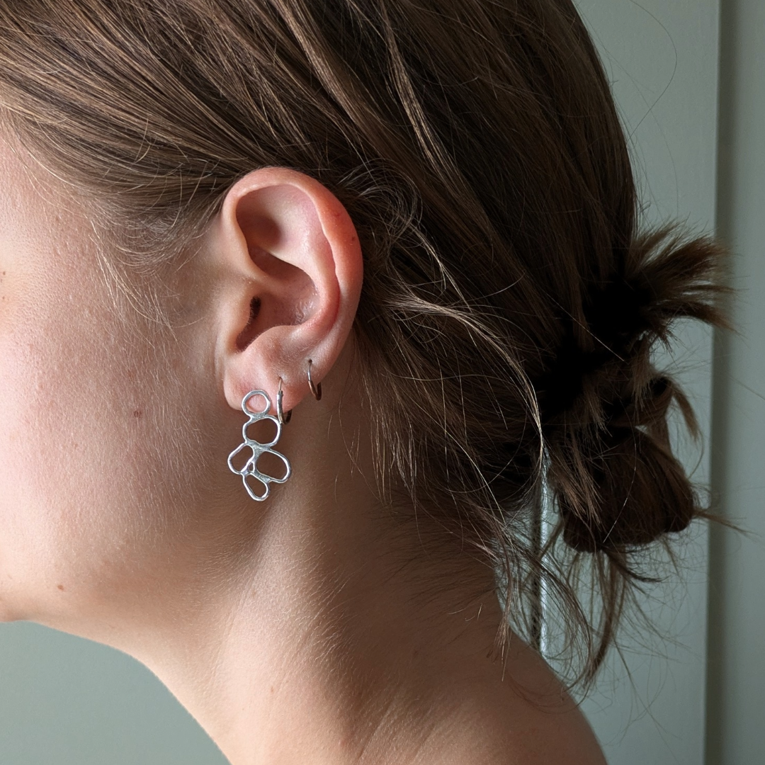 Close up of Stacked cairn studs in ear