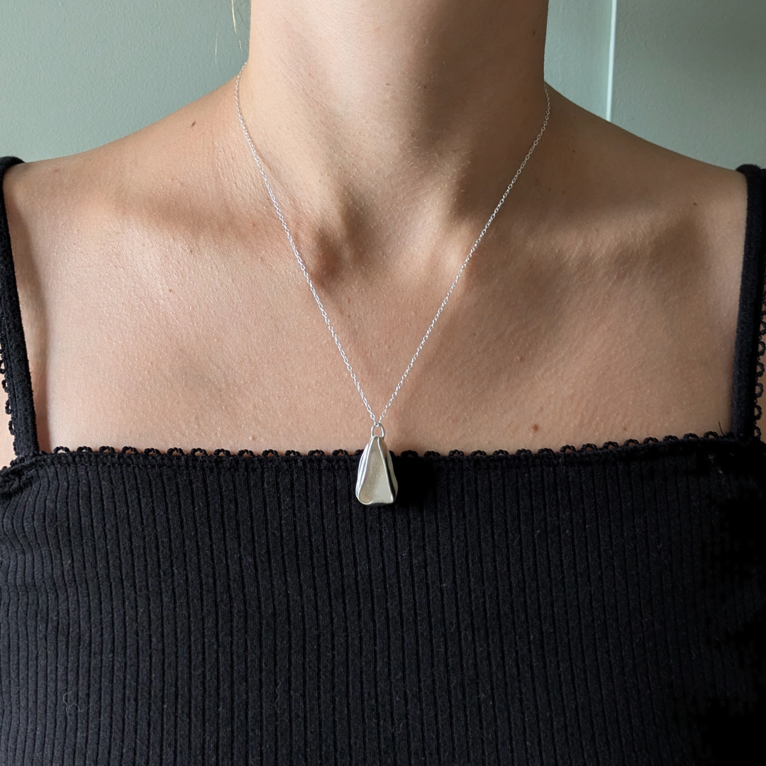 Close up of white sea glass pendant