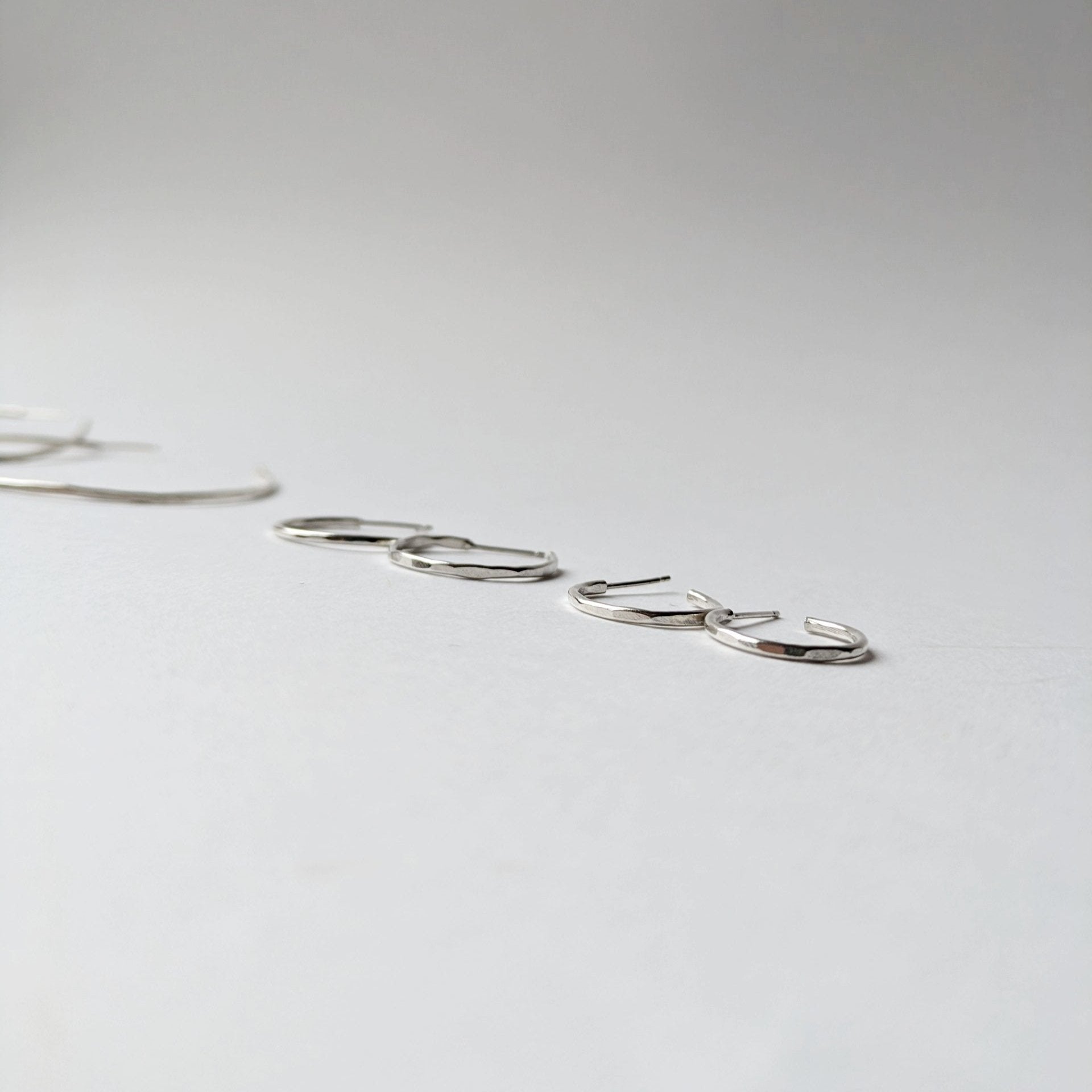 Small, medium and extra large hammered hoops on white background