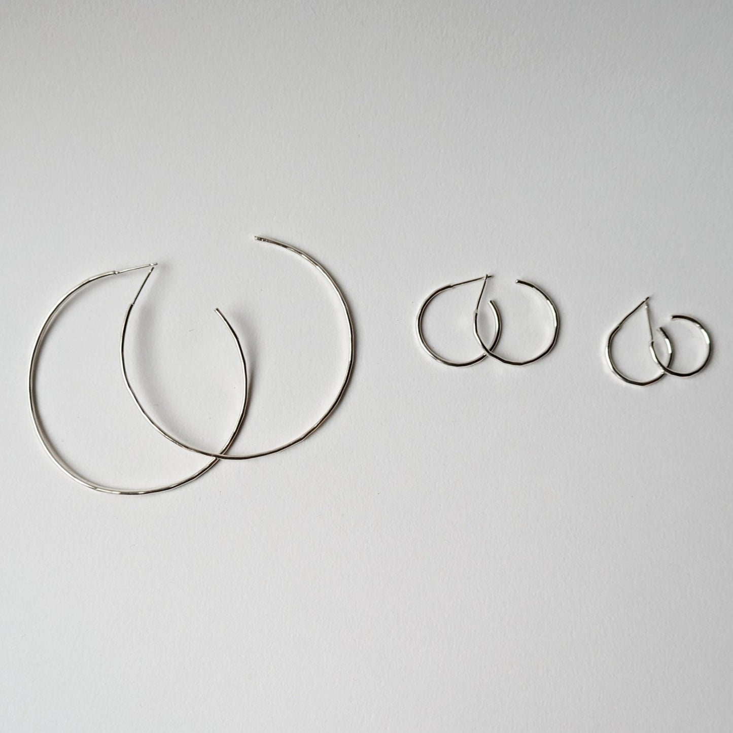 Small, medium and extra large hammered hoops on white background
