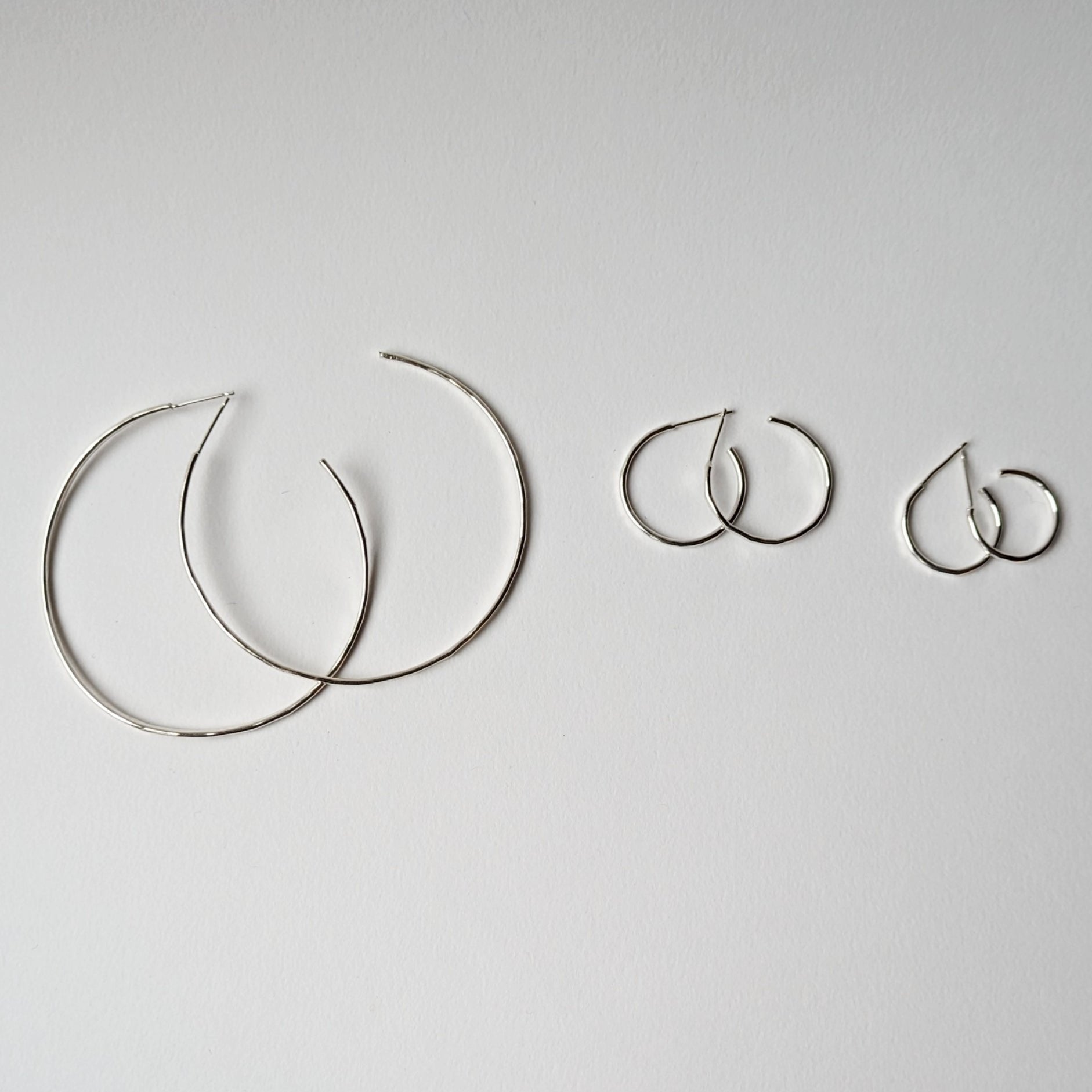 Small, medium and extra large hammered hoops on white background