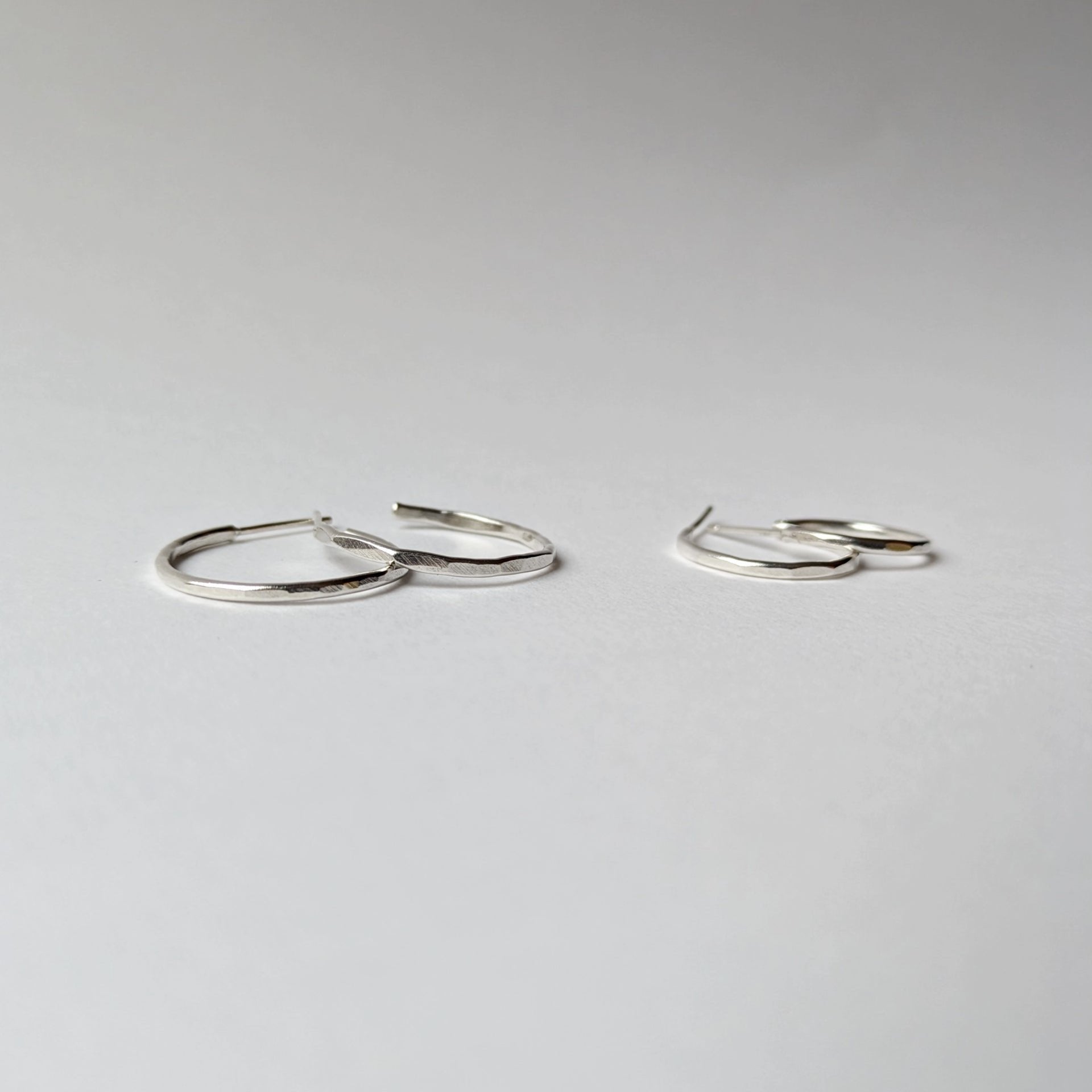 Small and medium hammered hoops on white background