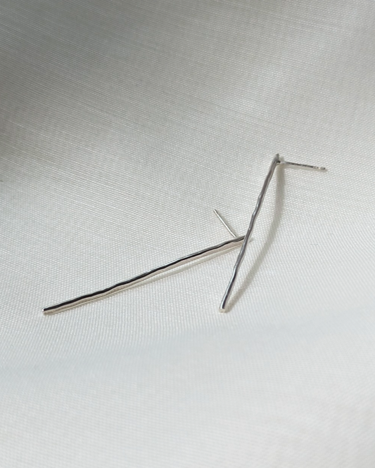 Hammered line studs on white silk