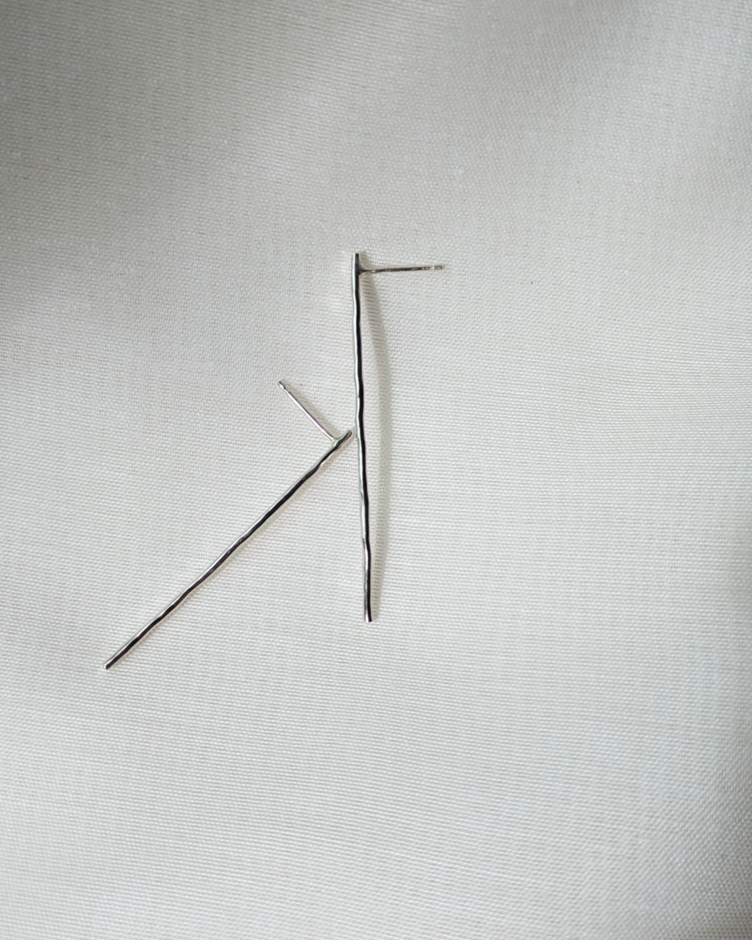 Hammered line studs on white silk
