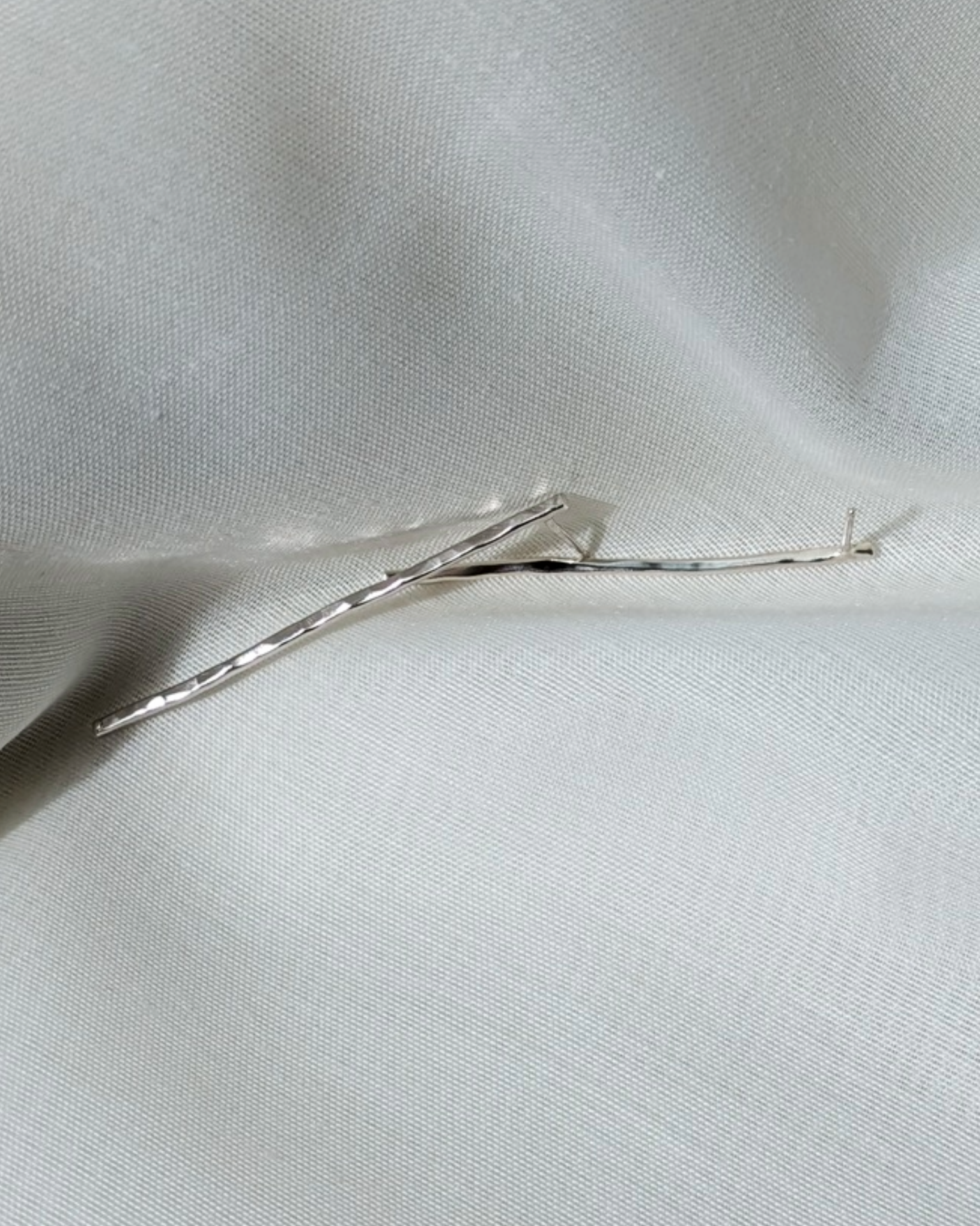 Hammered line studs on white silk