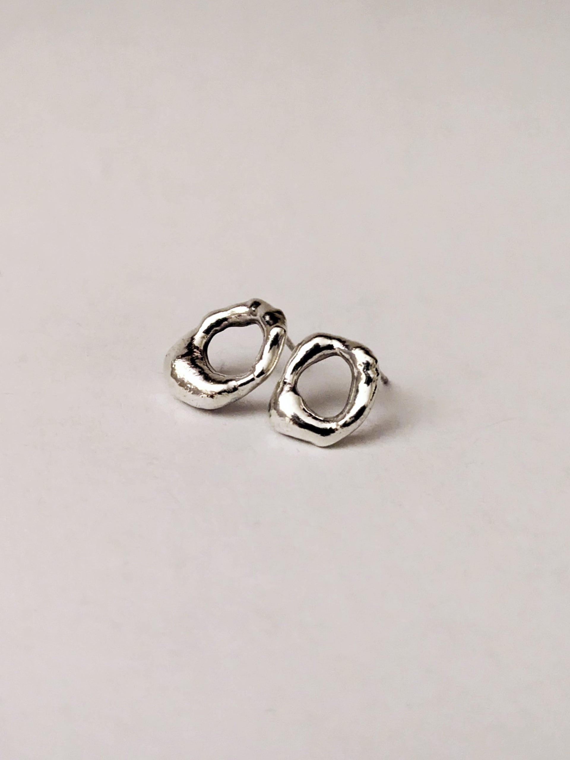 Mini molten studs on a light beige background