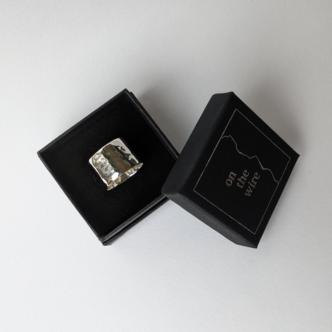 Hammered wide silver ring in branded gift box