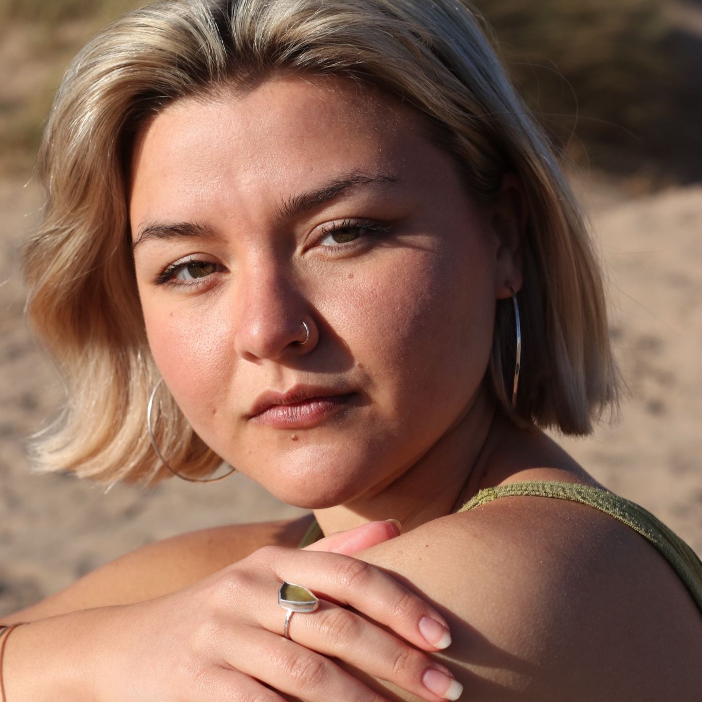 Woman on beach wearing green sea glass silver ring