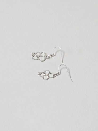 Organic shaped silver drop earrings on white background