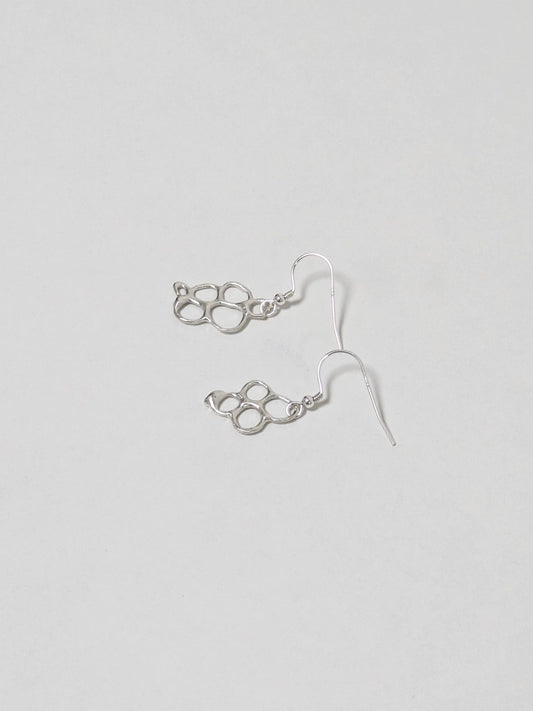 Organic shaped silver drop earrings on white background
