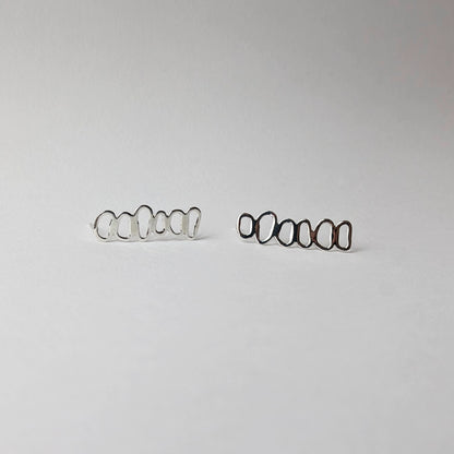 A pair of stacked pebble earrings horizontal on a white background