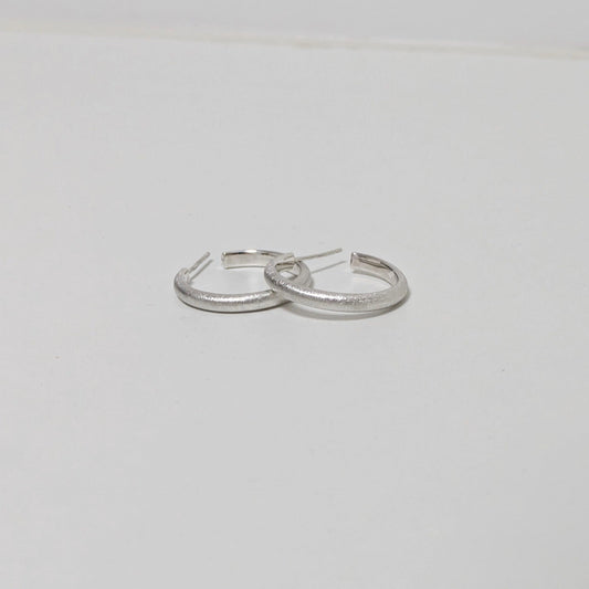 Two satin textured thin hoops on white background