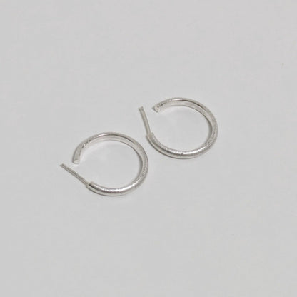 Two satin textured thin hoops on white background